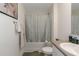 Bathroom featuring a shower with patterned curtain, toilet, sink, and white tile at 294 Broder Farms Dr, Stockbridge, GA 30281