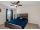 Bedrooom featuring a wooden bed frame, ceiling fan and window with plenty of natural light at 294 Broder Farms Dr, Stockbridge, GA 30281