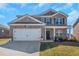Charming two-story brick home with a well-manicured lawn and a two-car garage at 294 Broder Farms Dr, Stockbridge, GA 30281