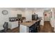 Modern kitchen with stainless steel appliances, granite counters, and an island with bar seating at 294 Broder Farms Dr, Stockbridge, GA 30281