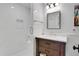 Modern bathroom featuring a white tile shower and a dark wood vanity with marble countertop at 11 Collier Nw Ln, Atlanta, GA 30305