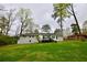 Back exterior showing a large yard and a deck at 2447 Old Peachtree Rd, Duluth, GA 30097