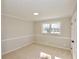 Neutral-toned bedroom featuring a flush mount light fixture and carpet flooring at 2447 Old Peachtree Rd, Duluth, GA 30097