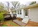 Back exterior featuring brick siding, a deck with stairs, and a walk-up ramp at 2447 Old Peachtree Rd, Duluth, GA 30097