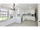 Bright eat-in kitchen with white cabinetry, quartz countertops, and stainless steel appliances at 2447 Old Peachtree Rd, Duluth, GA 30097