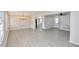 Large open-concept living room with updated vinyl flooring and plenty of natural light at 2447 Old Peachtree Rd, Duluth, GA 30097