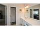 Clean bathroom featuring white cabinetry, a large mirror, and an adjacent room at 303 Dexter Dr, Woodstock, GA 30188
