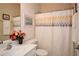 Well-lit bathroom showcasing a white vanity, framed mirror, and patterned shower curtain at 303 Dexter Dr, Woodstock, GA 30188
