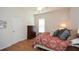 Comfortable bedroom featuring hardwood floors, a chest of drawers, and natural light at 303 Dexter Dr, Woodstock, GA 30188