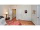 Inviting bedroom with hardwood floors, a side table, and a view into other rooms at 303 Dexter Dr, Woodstock, GA 30188