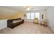 Upstairs bonus room with a leather couch, natural light and neutral carpet at 303 Dexter Dr, Woodstock, GA 30188