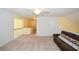 Bright bonus room features neutral carpet, ceiling fan, and access to hallway and storage at 303 Dexter Dr, Woodstock, GA 30188