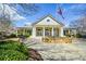 Community clubhouse with flowering trees, benches and manicured landscaping at 303 Dexter Dr, Woodstock, GA 30188