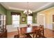 Formal dining room with hardwood floors, a stylish chandelier, and green walls at 303 Dexter Dr, Woodstock, GA 30188