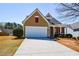 This home offers a well-manicured lawn, a two-car garage, and inviting curb appeal at 303 Dexter Dr, Woodstock, GA 30188