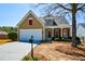 Charming home with a well-maintained lawn, red shutters, and inviting front porch at 303 Dexter Dr, Woodstock, GA 30188