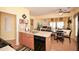 Bright kitchen offering a breakfast nook, a center island, and views to the living area at 303 Dexter Dr, Woodstock, GA 30188