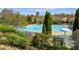 Large community pool surrounded by lush landscaping and comfortable lounge chairs offers relaxation and recreation at 303 Dexter Dr, Woodstock, GA 30188