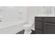 Bathroom features a bathtub and a gray vanity at 320 Mahone Dr, Lilburn, GA 30047