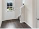 Entryway with dark wood floors, white walls, a staircase, and a view of the front door at 320 Mahone Dr, Lilburn, GA 30047