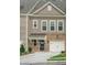 Charming two-story townhome with brick accents and an attached one car garage at 320 Mahone Dr, Lilburn, GA 30047