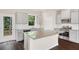 Modern kitchen features gray cabinets, a kitchen island, stainless appliances, and backyard access at 320 Mahone Dr, Lilburn, GA 30047