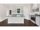 Modern kitchen with stainless steel appliances, granite countertops, and hardwood floors at 320 Mahone Dr, Lilburn, GA 30047