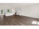 Bright living room with hardwood floors, an open kitchen, and lots of natural light at 320 Mahone Dr, Lilburn, GA 30047