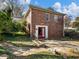 Charming brick home featuring a red door, and a backyard with stone walkway at 46 W Belle Isle Rd, Atlanta, GA 30342