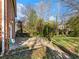 Brick home's backyard with mature trees and grass, ready for outdoor enjoyment at 46 W Belle Isle Rd, Atlanta, GA 30342