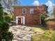 Brick home's backyard showing brick wall, stone pavers, and mature landscaping at 46 W Belle Isle Rd, Atlanta, GA 30342
