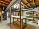 Unfinished basement with exposed ceiling, work table, shelving and water heater at 46 W Belle Isle Rd, Atlanta, GA 30342