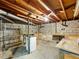 Unfinished basement with exposed ceiling, concrete walls, and work table at 46 W Belle Isle Rd, Atlanta, GA 30342