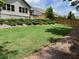 Newly sodded backyard featuring a wooden fence and tasteful landscaping at 5745 Pickens Garden Ln, Powder Springs, GA 30127