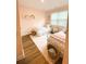 Charming bedroom featuring two twin beds, hardwood floors, and a light pink color palette at 5745 Pickens Garden Ln, Powder Springs, GA 30127