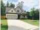 Charming home with a well-manicured lawn and concrete driveway at 5745 Pickens Garden Ln, Powder Springs, GA 30127