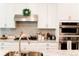 Bright kitchen features white cabinets, stainless appliances, and granite countertops at 5745 Pickens Garden Ln, Powder Springs, GA 30127