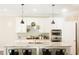 Bright kitchen features white cabinets, stainless appliances, large island with counter seating, and hardwood flooring at 5745 Pickens Garden Ln, Powder Springs, GA 30127