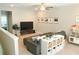 Charming living room features a comfortable grey sofa and a media center with TV at 5745 Pickens Garden Ln, Powder Springs, GA 30127