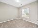 Cozy bedroom with a window offering natural light and neutral color scheme at 2373 Shady Maple Ln, Loganville, GA 30052