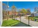 Balcony with artificial turf, clear glass railing, and neighborhood views under a bright blue sky at 548 Fletcher St, Atlanta, GA 30310