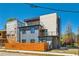 Rear elevation of this modern three-story home with a wood fence and glass-enclosed balconies at 548 Fletcher St, Atlanta, GA 30310