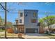 Modern three-story home boasts gray siding, a glass-enclosed balcony, and an attached two-car garage at 548 Fletcher St, Atlanta, GA 30310