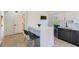 A modern, well-lit kitchen featuring an island with seating, stainless steel sink, and dark wood lower cabinets at 548 Fletcher St, Atlanta, GA 30310