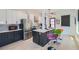 Modern kitchen featuring stainless steel appliances, an island with counter seating, and stylish white and gray cabinetry at 548 Fletcher St, Atlanta, GA 30310