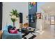 Stylish living room with a vibrant blue sofa, a sleek black and white rug, and a wall-mounted TV with shelving at 548 Fletcher St, Atlanta, GA 30310