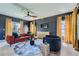 Cozy living room featuring modern furniture, stylish decor, large windows with gold curtains, and a ceiling fan at 548 Fletcher St, Atlanta, GA 30310