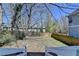 View of backyard from the top of deck stairs, with trees, grass, and wooden fence at 73 Atlanta Sw Ave, Atlanta, GA 30315