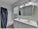 Inviting bathroom with double sinks, white cabinets, and shower with dark curtain at 73 Atlanta Sw Ave, Atlanta, GA 30315