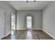 Bright bedroom with hardwood floors, neutral paint, ceiling fan, and exterior door at 73 Atlanta Sw Ave, Atlanta, GA 30315
